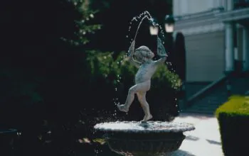 person in water fountain during daytime